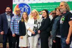 Arts Advocates posing at step and repeat