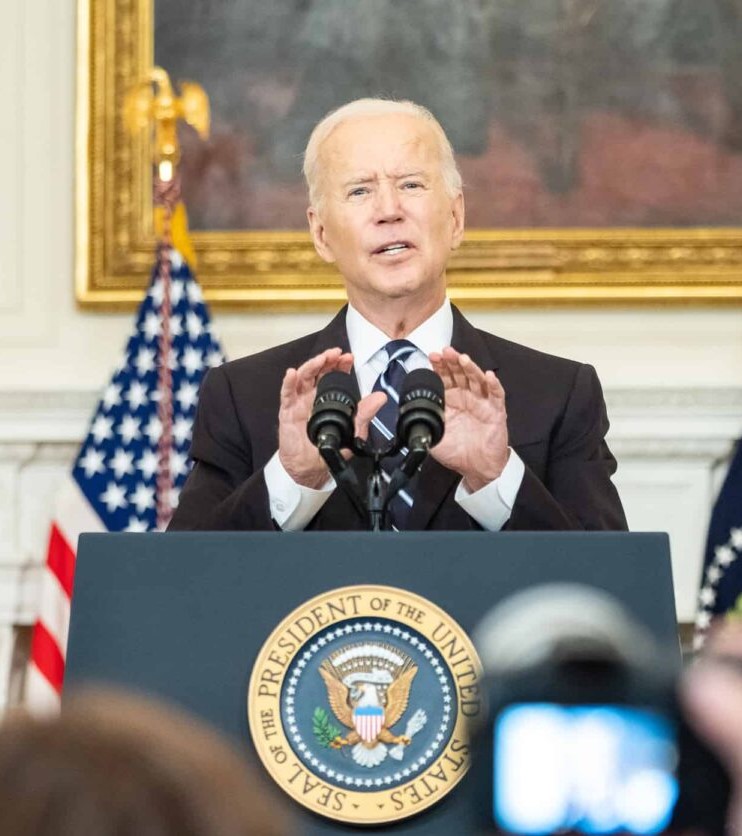 President Biden speaking at a podium.
