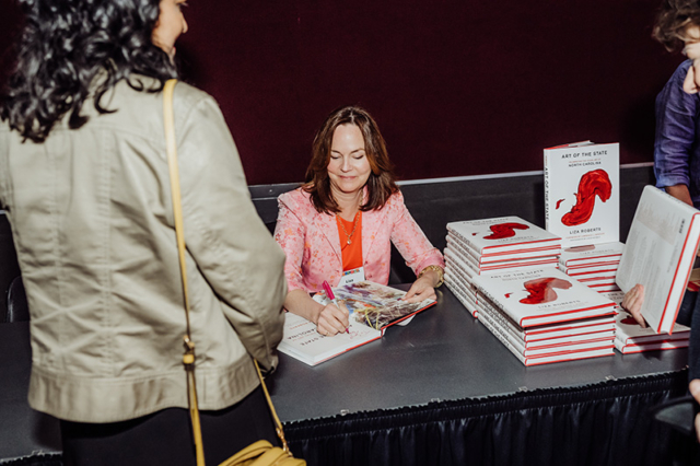 Liza Roberts signing books