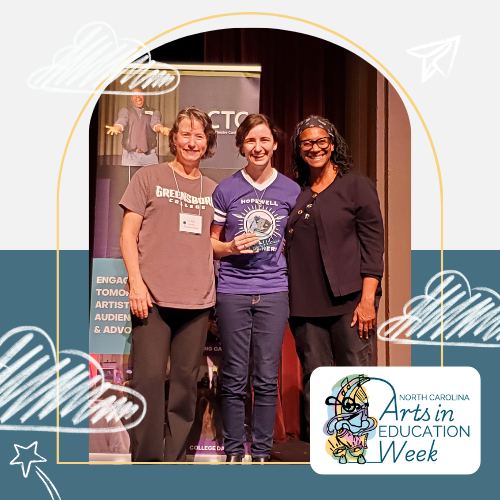 Picture of Lilly Allemond standing with festival adjudicators, Josephine Hall and Donna Bradby.  Lilly is holding the award and smiling. She is a white woman with short brown hair and is wearing an blue tee shirt with the name of her school on it and dark jeans.