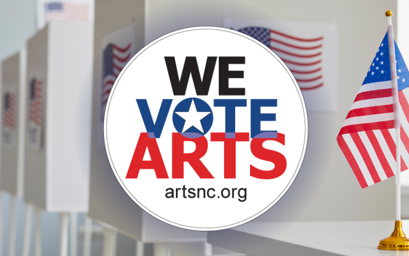 A picture of voting booths and an american flag on a table. The We Vote Arts Logo is in front of the image.