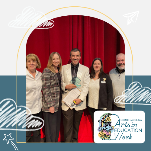Picture of Adam Faw accepting his award in a group of other people.