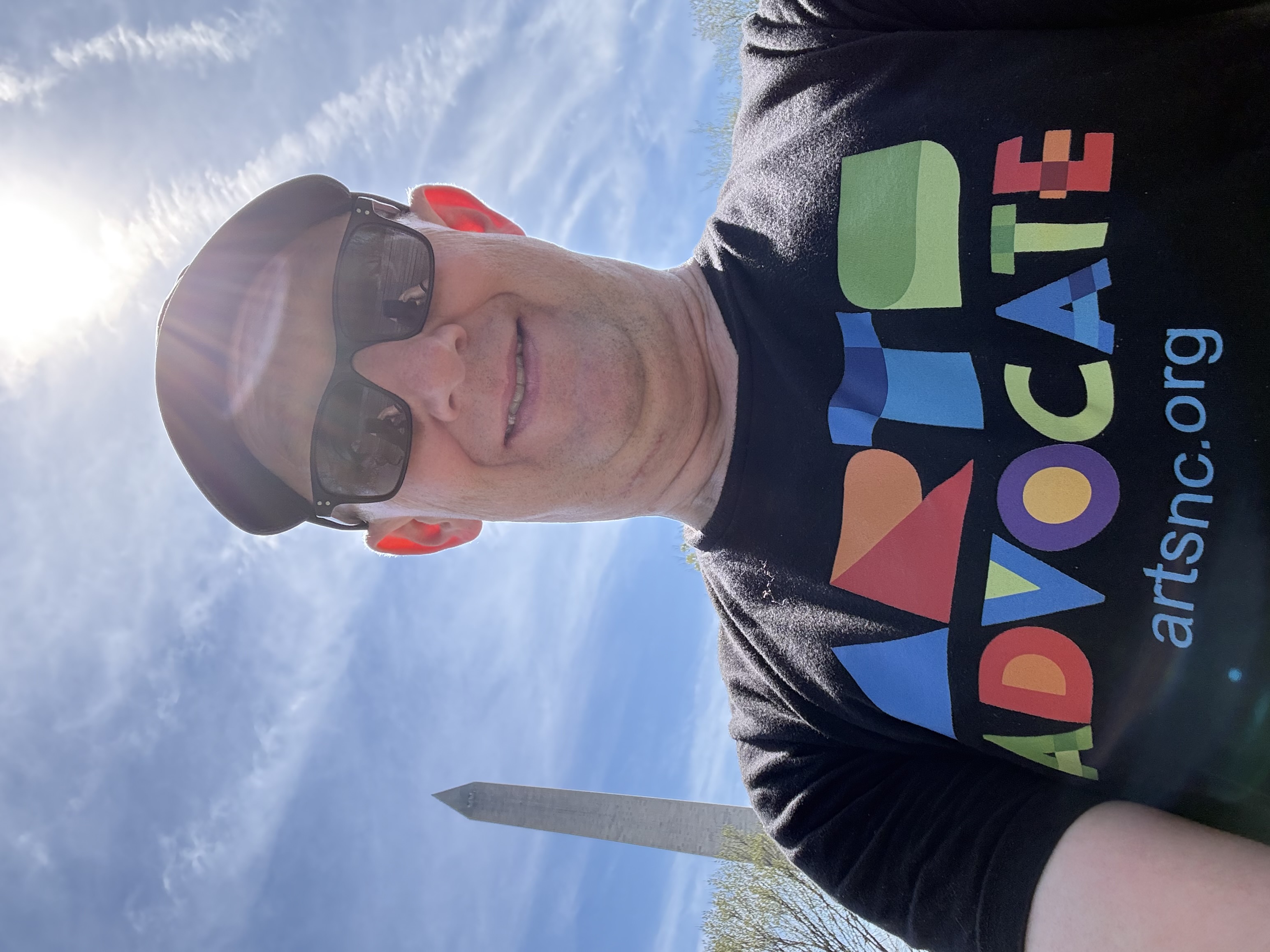 Nate McGaha with Arts Advocate T-shirt in front of Washington Monument